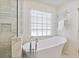 Modern bathroom with soaking tub, separate glass shower, and heated towel rack at 370 Landing Entry, Johns Creek, GA 30022