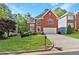 Charming two-story red brick home with a well-manicured lawn, arched windows, and attached garage at 370 Landing Entry, Johns Creek, GA 30022