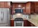 A kitchen features stainless appliances, granite counters and a tile backsplash at 370 Landing Entry, Johns Creek, GA 30022