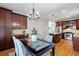 The open kitchen features wood cabinets, stainless steel appliances, and an adjacent dining area at 370 Landing Entry, Johns Creek, GA 30022
