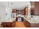 A kitchen showcases wood cabinets, granite counters, stainless appliances and a center island at 370 Landing Entry, Johns Creek, GA 30022