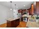 Kitchen features wooden cabinets, stainless steel appliances, and granite counters with seating at 370 Landing Entry, Johns Creek, GA 30022