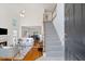 Bright living room with soaring ceilings, hardwood floors, fireplace, and open staircase at 370 Landing Entry, Johns Creek, GA 30022