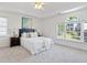 Spacious main bedroom with tray ceilings, large windows, and neutral carpet at 370 Landing Entry, Johns Creek, GA 30022