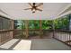 An outdoor screened porch with wood railings overlooking lush green trees and plantings at 370 Landing Entry, Johns Creek, GA 30022