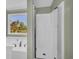 Bathroom view showcasing a shower with glass door and bathtub by the window with a view at 14807 Highway 36, Covington, GA 30014