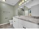 Bathroom with tile flooring, white cabinets, and granite countertops, providing ample space at 14807 Highway 36, Covington, GA 30014