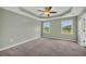 Spacious primary bedroom features a ceiling fan, carpeted floors, and a backyard view at 14807 Highway 36, Covington, GA 30014