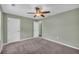 Bedroom featuring a ceiling fan, carpeted floor, and multiple doors at 14807 Highway 36, Covington, GA 30014
