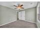 Bedroom featuring a ceiling fan, carpeted floor, and a double door closet at 14807 Highway 36, Covington, GA 30014