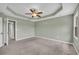 Primary bedroom featuring a ceiling fan, trey ceiling, carpeted floors, and an entrance way at 14807 Highway 36, Covington, GA 30014