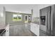 Open kitchen and dining area with stainless steel refrigerator and view to the fenced backyard at 14807 Highway 36, Covington, GA 30014