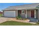 A charming exterior with a garage, flower beds and a walkway to the front door at 14807 Highway 36, Covington, GA 30014