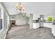 Open concept living room and kitchen area with brick fireplace and modern appliances at 14807 Highway 36, Covington, GA 30014