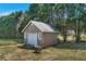 Exterior view of the shed nestled among large trees in the backyard of the property at 14807 Highway 36, Covington, GA 30014