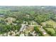 Wide aerial view of a residential area featuring mature trees, lush landscapes and roads at 1830 Lost Mountain Rd, Powder Springs, GA 30127