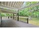 Spacious back porch overlooking a large backyard with mature trees at 1830 Lost Mountain Rd, Powder Springs, GA 30127