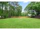 Large backyard with privacy fence and green grass at 1830 Lost Mountain Rd, Powder Springs, GA 30127