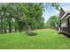Expansive backyard featuring mature trees, a lush lawn, and an inviting deck area for outdoor relaxation at 1830 Lost Mountain Rd, Powder Springs, GA 30127