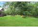 Large backyard with mature trees and a playset at 1830 Lost Mountain Rd, Powder Springs, GA 30127