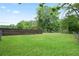 Spacious backyard showcasing a combination of privacy fencing and open green space at 1830 Lost Mountain Rd, Powder Springs, GA 30127