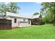Exterior view of the white home showing the back porch and large backyard at 1830 Lost Mountain Rd, Powder Springs, GA 30127