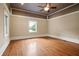 Empty bedroom with hardwood floors, neutral walls, a window, and walk-in closet at 1830 Lost Mountain Rd, Powder Springs, GA 30127