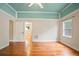 Bright bedroom features hardwood floors, ceiling fan, and light blue trim at 1830 Lost Mountain Rd, Powder Springs, GA 30127
