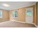 Bedroom featuring carpet flooring, neutral walls, and natural light from the window and glass paneled door at 1830 Lost Mountain Rd, Powder Springs, GA 30127