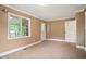 Bedroom featuring carpet flooring, neutral walls, and two points of entry: a door and an open entryway at 1830 Lost Mountain Rd, Powder Springs, GA 30127
