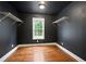 Dark colored bedroom with hardwood floors and a window at 1830 Lost Mountain Rd, Powder Springs, GA 30127