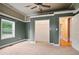 A bright bedroom featuring carpet flooring, a wooden ceiling, and a view of the closet at 1830 Lost Mountain Rd, Powder Springs, GA 30127