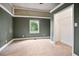 Empty bedroom featuring neutral colored walls, light carpet, and a walk-in closet at 1830 Lost Mountain Rd, Powder Springs, GA 30127