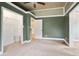 Spacious bedroom with carpet floors, ceiling fan, wooden ceiling, walk-in closet, and neutral green walls at 1830 Lost Mountain Rd, Powder Springs, GA 30127