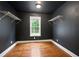 Walk-in closet with hardwood floors, dark paint, and metal shelving at 1830 Lost Mountain Rd, Powder Springs, GA 30127