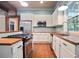 Well-appointed kitchen featuring stainless steel appliances and hardwood countertops at 1830 Lost Mountain Rd, Powder Springs, GA 30127