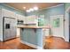 A charming kitchen with white cabinets, stainless steel appliances, butcher block countertops, and an island at 1830 Lost Mountain Rd, Powder Springs, GA 30127