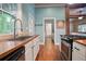 Kitchen view showcasing butcher block countertops, appliances, and a view to the outdoors at 1830 Lost Mountain Rd, Powder Springs, GA 30127