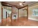 Open-concept living area with a fireplace, exposed beams, and easy access to the kitchen at 1830 Lost Mountain Rd, Powder Springs, GA 30127