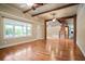 View of the open concept living room showing hardwood floors and the brick fireplace at 1830 Lost Mountain Rd, Powder Springs, GA 30127