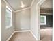 Neutral, carpeted sitting area with crown moulding and natural light from the large window at 1830 Lost Mountain Rd, Powder Springs, GA 30127