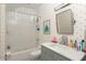 Bright bathroom featuring modern vanity, patterned wallpaper, and tub with shower at 248 Madison Ave, Decatur, GA 30030