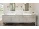 Bright bathroom featuring double sinks, marble backsplash, sconces, and chrome framed mirrors at 248 Madison Ave, Decatur, GA 30030