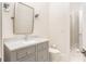 Bathroom with vanity, marble countertop, and chrome faucet, with doorway to shower space at 248 Madison Ave, Decatur, GA 30030