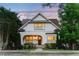 Charming two-story home featuring an arched front porch and beautifully landscaped front yard at 248 Madison Ave, Decatur, GA 30030