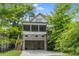Two-story house with brick garage, screened porch, and mature trees at 248 Madison Ave, Decatur, GA 30030