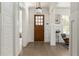 Bright foyer with hardwood floors, paneled walls, and craftsman style front door at 248 Madison Ave, Decatur, GA 30030