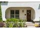 Close-up of home's entry with beautiful wood door and manicured landscaping at 248 Madison Ave, Decatur, GA 30030