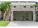 Spacious garage with brick facade, wooden staircase, and access door, perfect for secure parking and extra storage at 248 Madison Ave, Decatur, GA 30030