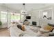 Bright living room boasts a stone fireplace, modern lighting, and doors to an outdoor living space at 248 Madison Ave, Decatur, GA 30030